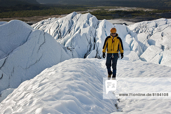 Mountaineer hiking along Matanuska Glacier
