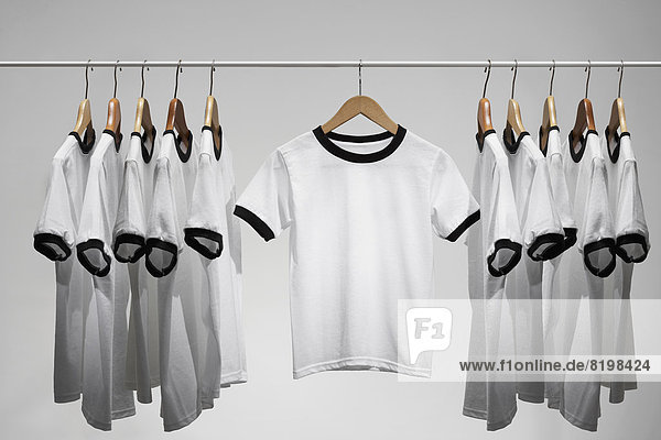 Football shirts on clothes hangers  studio shot