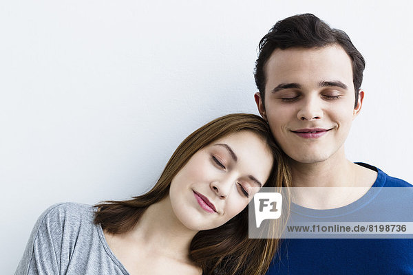 Germany  Bavaria  Munich  Young couple with eyes closed  smiling