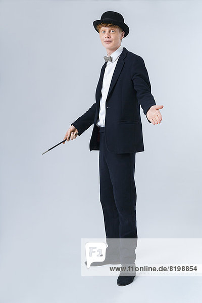 Portrait of young man holding magic wand