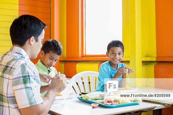 Junge - Person  Menschlicher Vater  Hispanier  Restaurant  essen  essend  isst