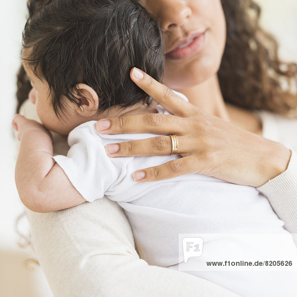 Hispanic mother holding infant son