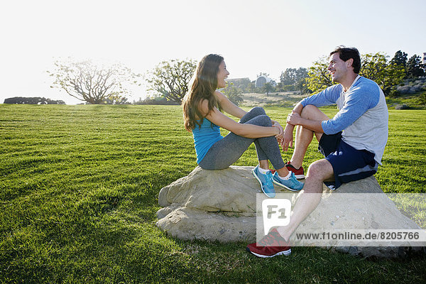 Couple wearing workout gear in park