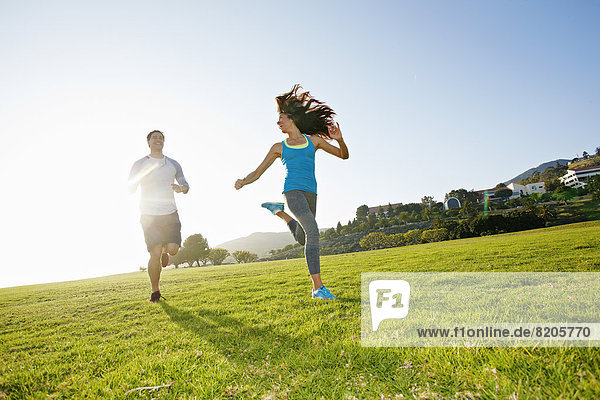 Couple running together in park