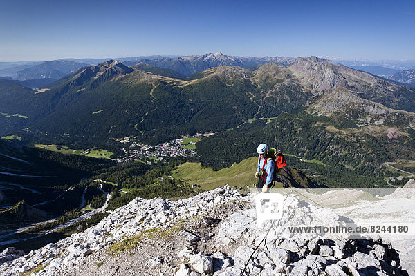Mountain climber ascending the Via Ferrata Bolver Lugli climbing route on Cima di Vezzana Mountain