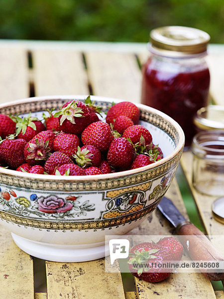 Bowl of strawberries on outdoor table