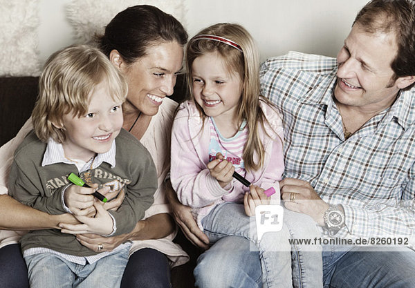 Happy family of four enjoying at home