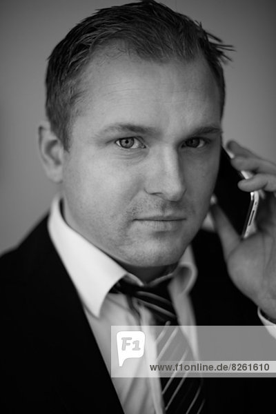 Portrait of businessman talking on phone