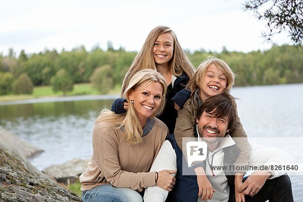 Portrait of family by lake