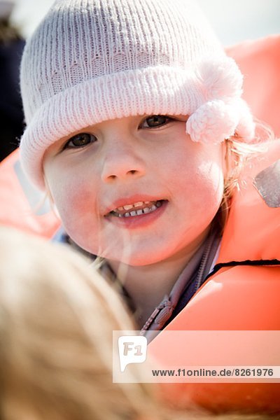 Portrait of girl wearing life vest and knit hat