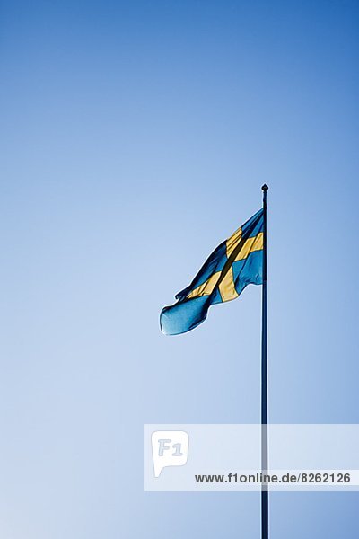 Swedish flag against blue sky