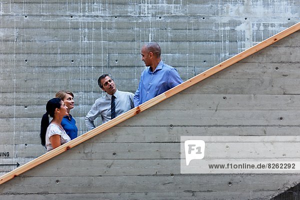 Men and women talking on stairs