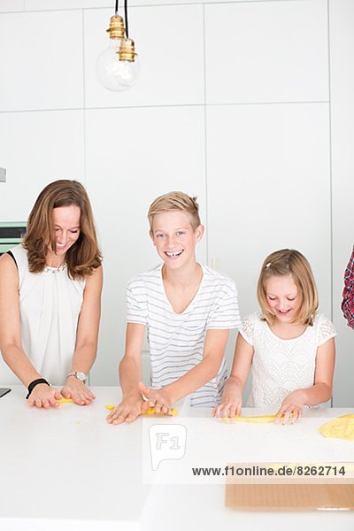 Mother and kids preparing saffron rolls