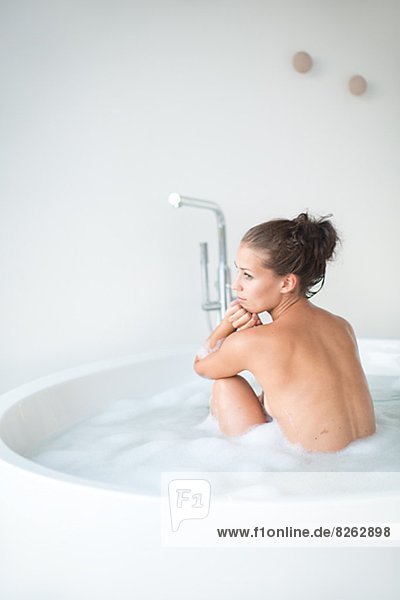 Young woman having bath