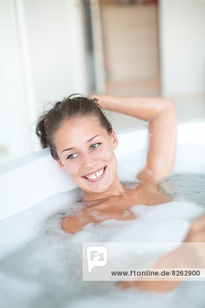 Young woman having bath