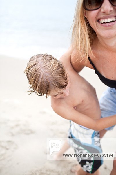 Happy woman with son on beach