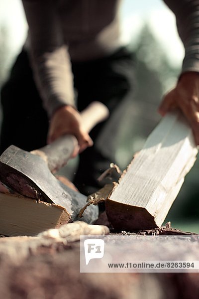 A woman chopping wood  Sweden.