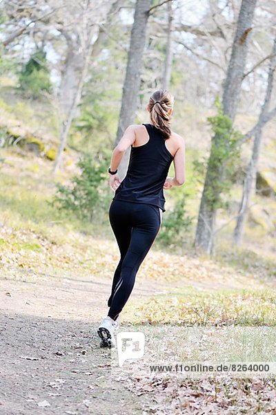 Woman jogging in a forest  Sweden.