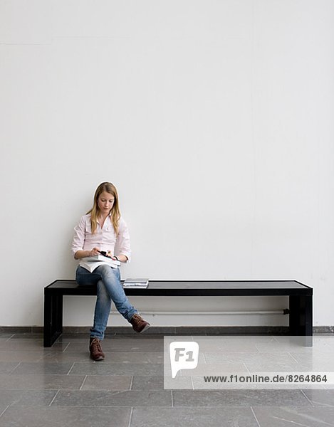 Young student sitting on bench