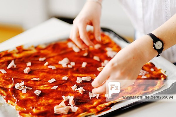 Woman preparing pizza  close-up
