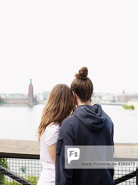 Rear view of young couple looking at view