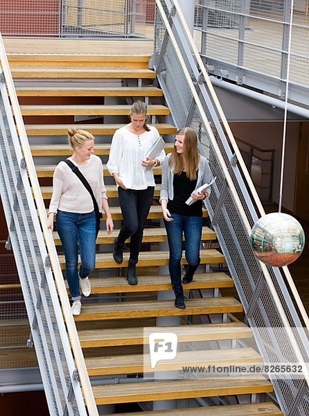 Three university student on stairs
