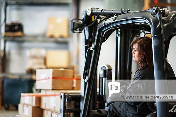 Woman driving forklift truck