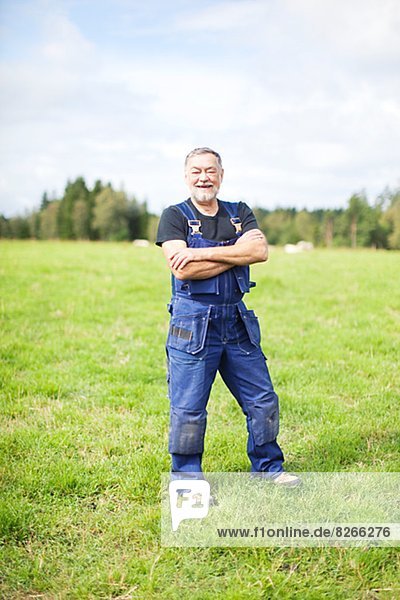 Senior farmer standing on field  Smaland  Sweden