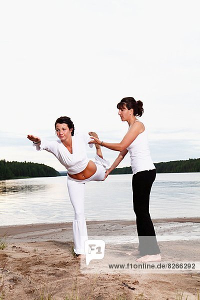 Women doing yoga at beach  Norrbotten  Sweden