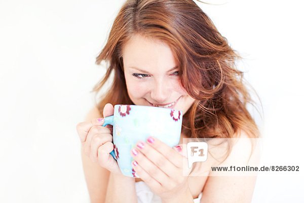 Smiling young woman with morning coffee