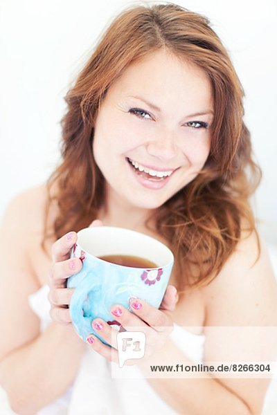 Smiling young woman with morning coffee