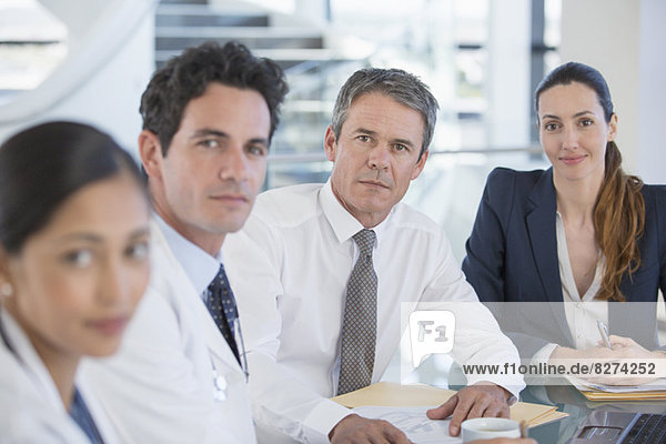 Portrait of doctors and business people in meeting