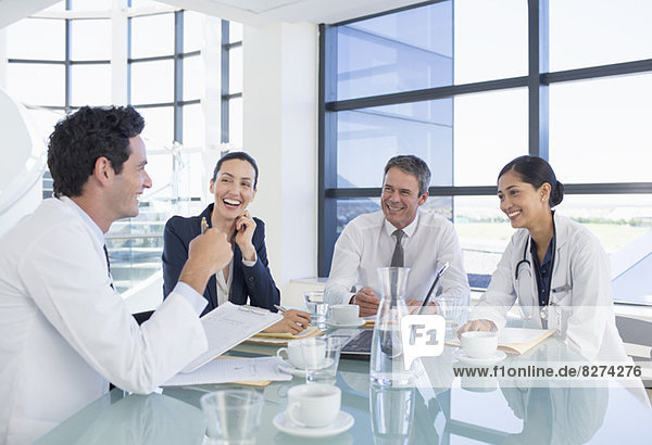 Doctors and business people talking in meeting