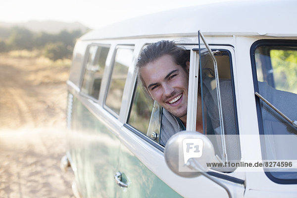 Man driving camper van on dirt road