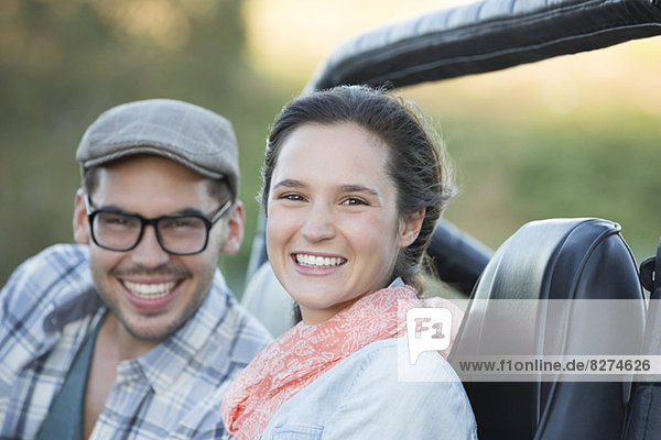 Portrait of smiling couple in sport utility vehicle