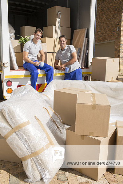 Movers sitting in moving van in driveway