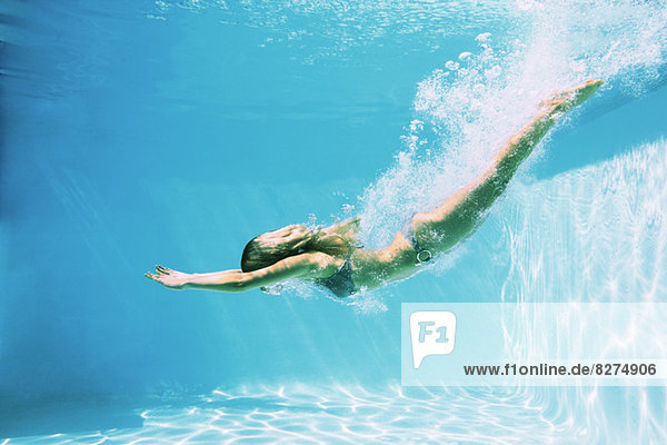 Woman diving into swimming pool