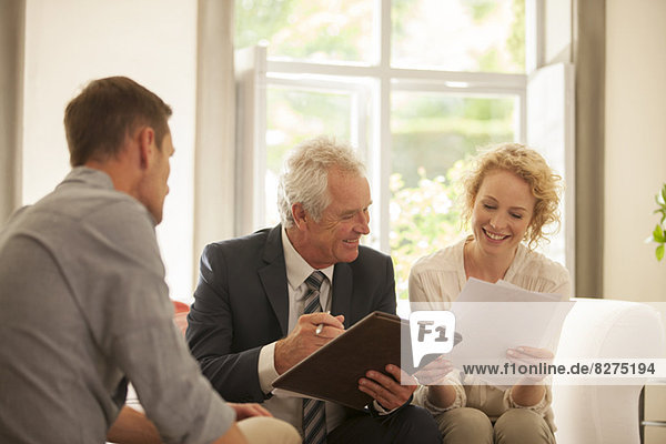 Financial advisor talking to couple in living room