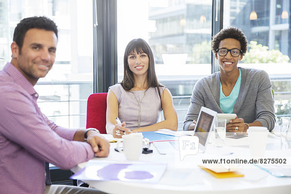 Portrait of business people smiling in meeting