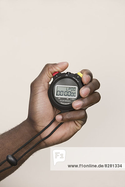Man holding digital stopwatch