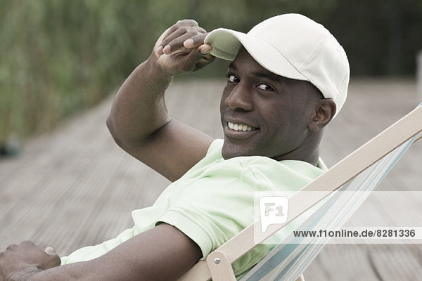 Man relaxing on deck chair