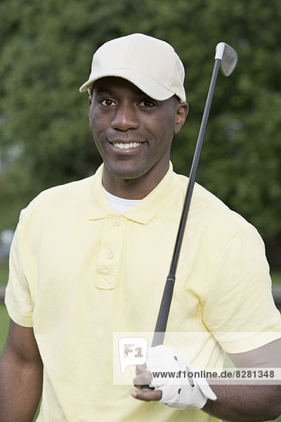 Portrait of man holding golf club