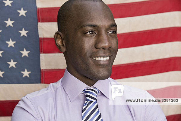 Happy businessman in front of American flag