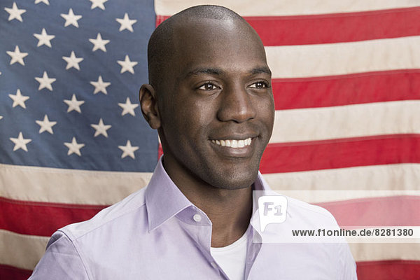 Happy man in front of American flag
