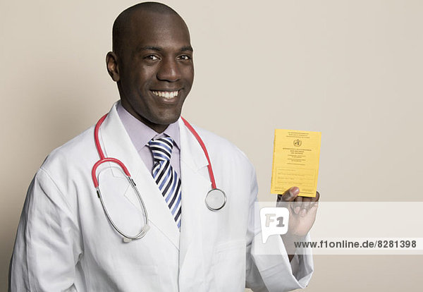 Doctor wearing stethoscope holding German Immunisation Certificate