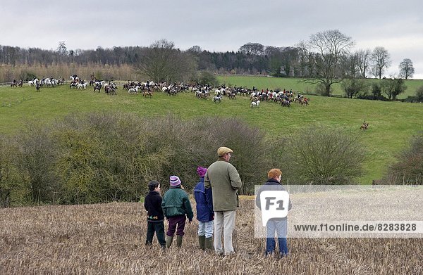A family gather to watch the Heythrop New Year's Day Hunt as it crosses the Stow-on-the-Wold fields in Oxfordshire