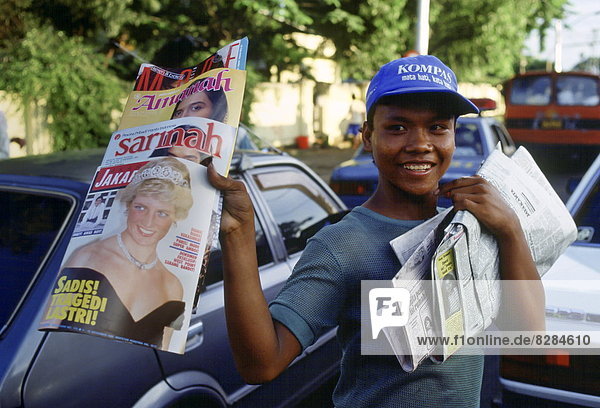 Boy sells magazines  in Jakarta  that have Diana  Princess of Wales on the cover in honour of her visit to Indonesia.