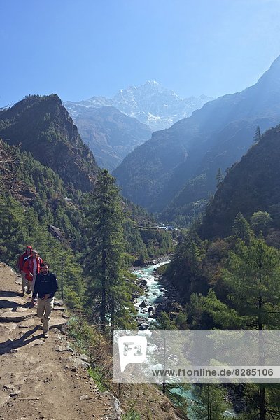 Trekkers on trail beside Dudh Koshi river  between Phakding and Namche  Chumoa  Everest Base Camp Trek  Solukhumbu  Nepal  Himalayas  Asia