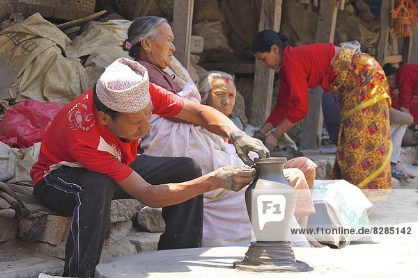 Potter turning pot on wheel  Potter's Square  Bhaktapur  Nepal  Asia
