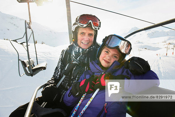 Portrait of grandmother and granddaughter on ski lift  Les Arcs  Haute-Savoie  France